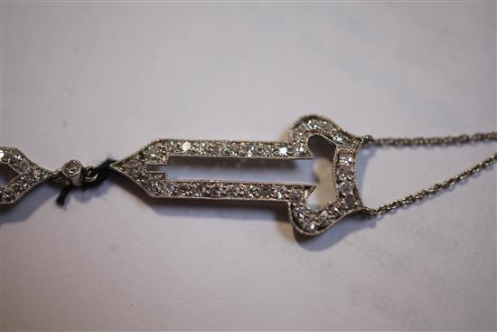 A 19201930s Art Deco 18ct gold, platinum and platinum set open work drop pendant, pendant 55mm.